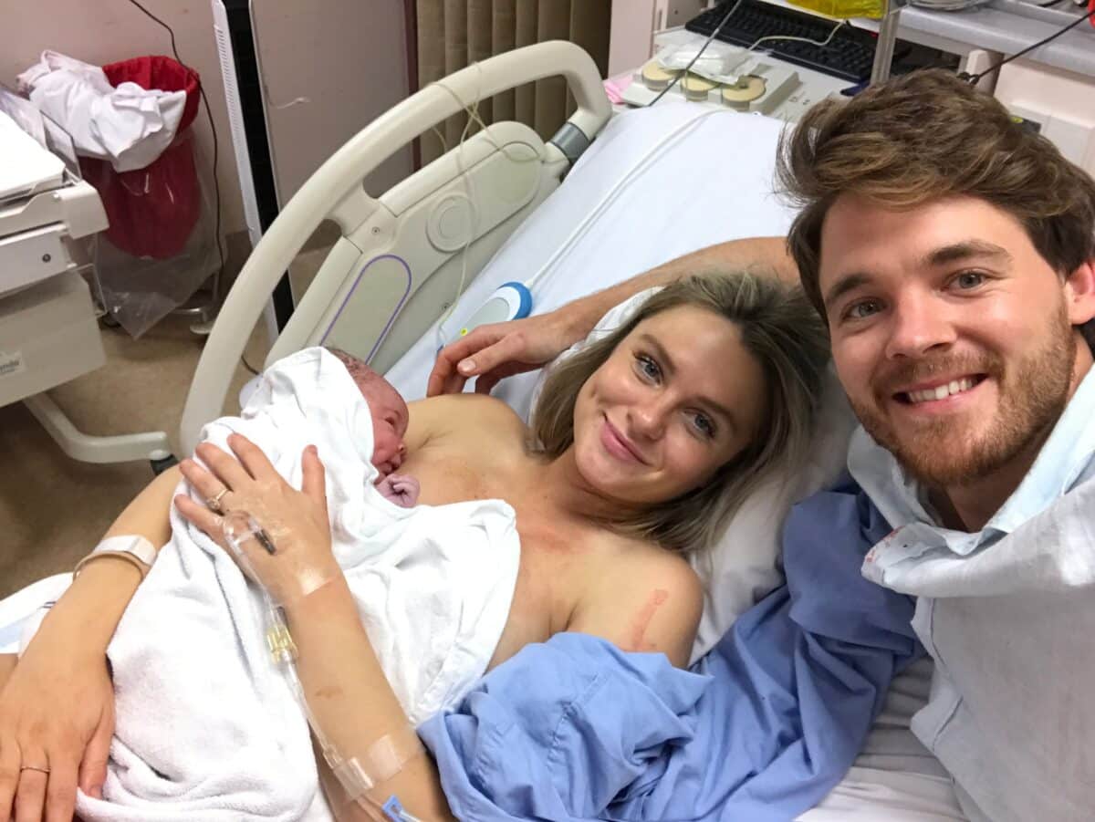 Nicola Cross and husband holding newborn post physiological birth