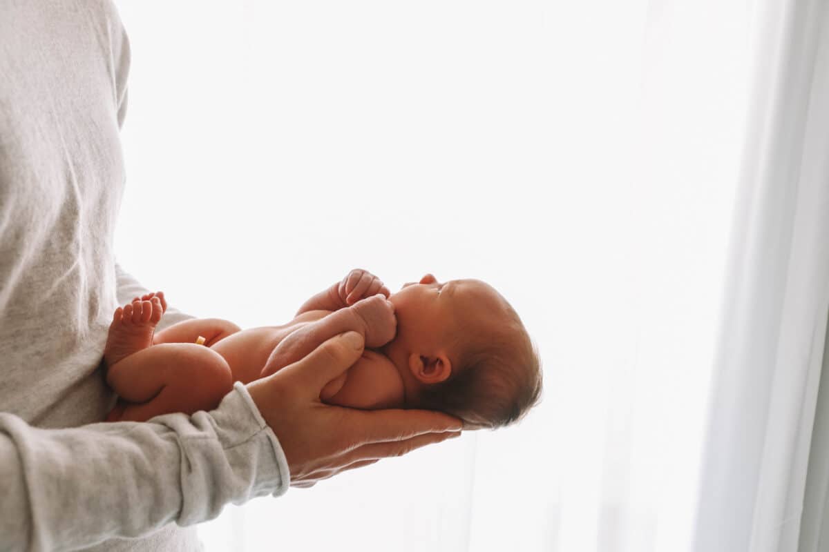 Newborn baby held by dad