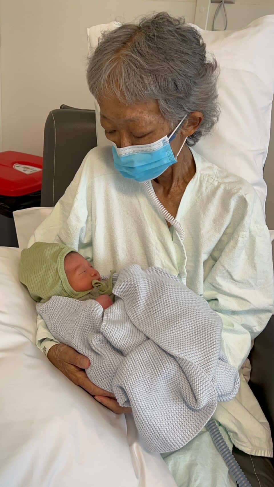 grandmother holding grandson during covid