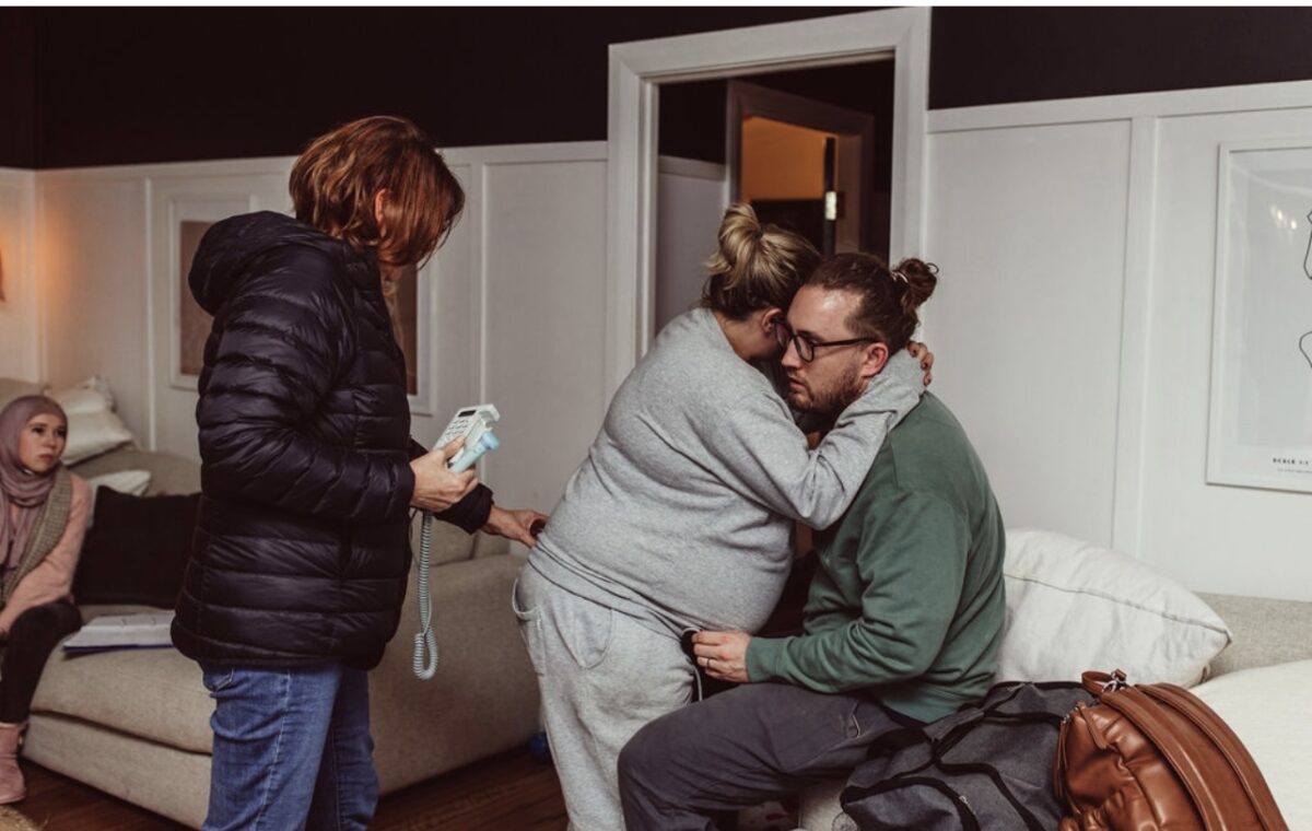 Melissa's home birth after a caesarean with midwife and husband