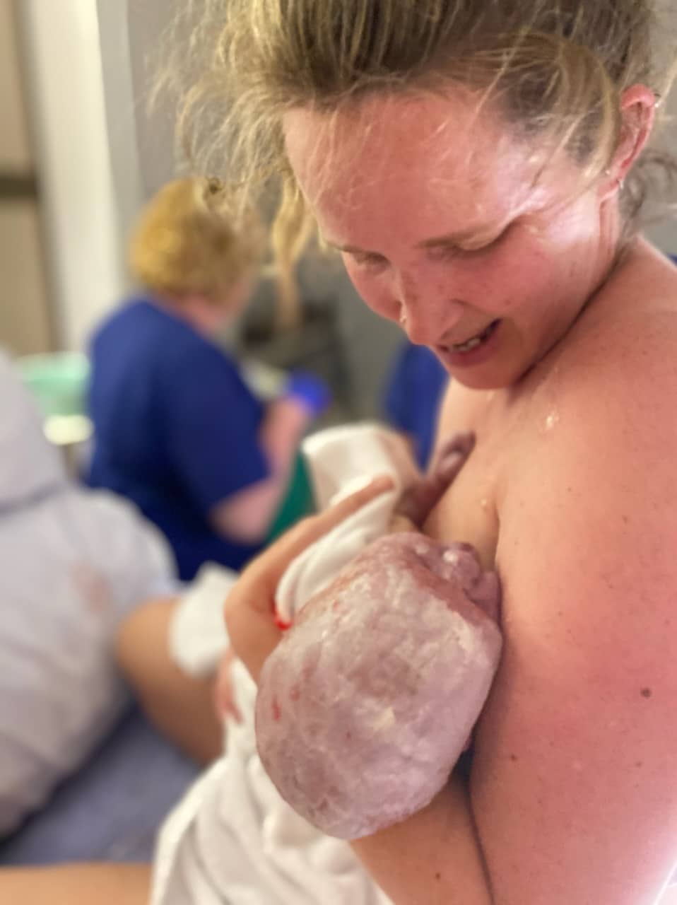 Dani holding baby just born after physiological vaginal birth